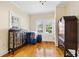 Bright bedroom featuring polished wood floors, vintage furniture, and ample natural light at 4626 O'Hear Ave, North Charleston, SC 29405