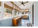 Bright sunroom with multiple windows, stylish wicker furniture, and a ceiling fan at 4626 O'Hear Ave, North Charleston, SC 29405