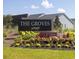 Landscaped entrance sign for 'The Groves' community by Beazer Homes on a sunny day with blue skies at 464 White Magnolia St, Moncks Corner, SC 29461
