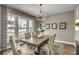 Bright dining room featuring hardwood floors, natural light, and elegant chandelier at 464 White Magnolia St, Moncks Corner, SC 29461