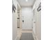 Hallway with neutral tones, a patterned rug, and white doors leads to various rooms, creating a seamless transition at 4856 Green Dolphin Way # Share 8, Kiawah Island, SC 29455