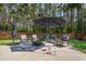 Spacious backyard with a patio area, swing set, and wooded backdrop at 491 Foxbank Plantation Blvd, Moncks Corner, SC 29461
