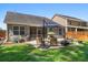 Well-maintained backyard with a patio seating area and lush green lawn at 491 Foxbank Plantation Blvd, Moncks Corner, SC 29461