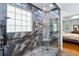 Bathroom showcasing the glass shower with pebble flooring, window, and modern tile surround at 491 Foxbank Plantation Blvd, Moncks Corner, SC 29461