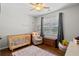Charming Bedroom featuring a wooden crib, area rug, and natural light from the window at 491 Foxbank Plantation Blvd, Moncks Corner, SC 29461