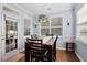 Dining room with dark wood furniture set, modern lighting, and bright windows at 491 Foxbank Plantation Blvd, Moncks Corner, SC 29461