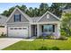 Attractive single-Gathering home with a two-car garage, a manicured lawn, and a charming front porch at 491 Foxbank Plantation Blvd, Moncks Corner, SC 29461