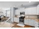 Bright kitchen with white cabinets, stainless steel appliances, and granite countertops at 491 Foxbank Plantation Blvd, Moncks Corner, SC 29461