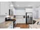 Modern kitchen featuring white cabinets, granite countertops, and stainless steel appliances at 491 Foxbank Plantation Blvd, Moncks Corner, SC 29461
