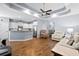 Open-concept living space with hardwood floors, a tray ceiling, and a modern kitchen with stainless steel appliances at 491 Foxbank Plantation Blvd, Moncks Corner, SC 29461