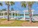 Bright community pool area with pergolas, palm trees and lounge chairs overlooking the lake at 491 Foxbank Plantation Blvd, Moncks Corner, SC 29461