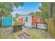 Backyard showcasing a fire pit, vibrant house colors and lush landscaping at 4928 Durant Ave, North Charleston, SC 29405