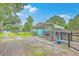 Fenced backyard with covered parking, lush lawn, and blue shed at 4928 Durant Ave, North Charleston, SC 29405
