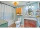 Charming bathroom featuring a vanity with granite countertop and shower with blue curtain at 4928 Durant Ave, North Charleston, SC 29405