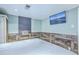 Bright bedroom with a flat screen TV, light-colored walls and wood paneling at 4928 Durant Ave, North Charleston, SC 29405