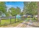 View of the backyard with the detached shed with a blue exterior and surrounding greenery at 4928 Durant Ave, North Charleston, SC 29405