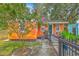 Inviting front of house with garden space, vibrant colored exterior and covered walkway to the entry at 4928 Durant Ave, North Charleston, SC 29405