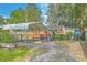 Charming home exterior with fenced yard, covered parking and mature trees for added privacy at 4928 Durant Ave, North Charleston, SC 29405