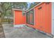 View of the house featuring a sliding glass door and vibrant orange color at 4928 Durant Ave, North Charleston, SC 29405