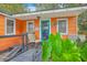 Inviting front porch with seating and lush greenery enhance the curb appeal of this colorful home at 4928 Durant Ave, North Charleston, SC 29405