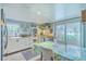 Bright kitchen featuring white cabinets, stainless steel appliances, and dining area at 4928 Durant Ave, North Charleston, SC 29405