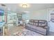 Open-concept living space with a comfortable sofa, desk, and view into the kitchen area at 4928 Durant Ave, North Charleston, SC 29405