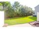This is a backyard featuring grass, trees, and a walking path to a patio at 4964 Hay Bale Ct, Summerville, SC 29485