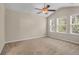 A bedroom featuring neutral paint, carpet, ceiling fan and three windows at 4964 Hay Bale Ct, Summerville, SC 29485