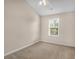A bright bedroom features neutral paint, carpet, a ceiling fan and a window at 4964 Hay Bale Ct, Summerville, SC 29485