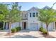 A charming townhome features a single-car garage, red door, and neatly trimmed trees and bushes at 4964 Hay Bale Ct, Summerville, SC 29485