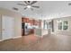 Open kitchen and dining area with wood floors, stainless appliances, and island with sink at 4964 Hay Bale Ct, Summerville, SC 29485