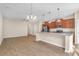 An open concept kitchen and living room with hardwood flooring and a view of the backyard at 4964 Hay Bale Ct, Summerville, SC 29485