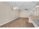 Bright open-concept living room featuring wood floors and modern light fixtures at 4964 Hay Bale Ct, Summerville, SC 29485