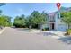 Street view showcasing townhomes with attached garages, trees, and sidewalks at 4964 Hay Bale Ct, Summerville, SC 29485
