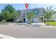 Street view of townhomes with attached garages, green trees, and well-kept landscaping at 4964 Hay Bale Ct, Summerville, SC 29485