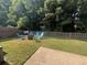 Private backyard oasis featuring a fire pit area with Adirondack chairs, a lounge area, and mature trees at 5008 W W Liberty Meadows Dr, Summerville, SC 29485