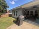 Wide angle view of a backyard with a covered patio and a well-maintained lawn at 5008 W W Liberty Meadows Dr, Summerville, SC 29485