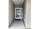 Close-up of the front door entrance with a storm door and welcoming mat at 5008 W W Liberty Meadows Dr, Summerville, SC 29485