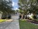 Lovely two-story home with gray siding, a two-car garage, and a welcoming front porch framed by mature trees at 5008 W W Liberty Meadows Dr, Summerville, SC 29485