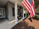Welcoming front porch with comfortable seating, decorative plants, and classic white columns at 5008 W W Liberty Meadows Dr, Summerville, SC 29485