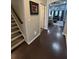 Inviting entryway with hardwood floors, stairs with carpet runner, and a glimpse into the open living space at 5008 W W Liberty Meadows Dr, Summerville, SC 29485