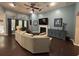 Spacious living room with hardwood floors, high ceilings, large windows, a cozy fireplace, and stylish furniture at 5008 W W Liberty Meadows Dr, Summerville, SC 29485