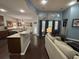 Open-concept living room with large windows, fireplace, and modern furnishings at 5008 W W Liberty Meadows Dr, Summerville, SC 29485
