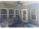 Cozy covered patio with comfortable seating, ceiling fan, and view of the backyard at 5008 W W Liberty Meadows Dr, Summerville, SC 29485