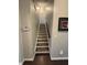 Staircase with dark wood treads and white risers leads to the upper level at 5008 W W Liberty Meadows Dr, Summerville, SC 29485
