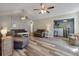 Open-concept living room with modern wood floors, bar area and lots of natural light at 5052 Hidden Forest Ln, North Charleston, SC 29420
