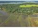 Stunning aerial view showcases waterfront homes, wooden docks and green vegetation on the water's edge at 5084 Timber Race Crse, Hollywood, SC 29449