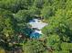 Aerial view of home with pool and screened-in porch, nestled among trees, providing privacy at 5084 Timber Race Crse, Hollywood, SC 29449