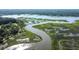 Expansive aerial view of winding river, marshland, and lush trees in a serene coastal setting at 5084 Timber Race Crse, Hollywood, SC 29449