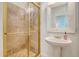 Elegant bathroom featuring a tiled shower, modern sink, and decorative mirror at 5084 Timber Race Crse, Hollywood, SC 29449
